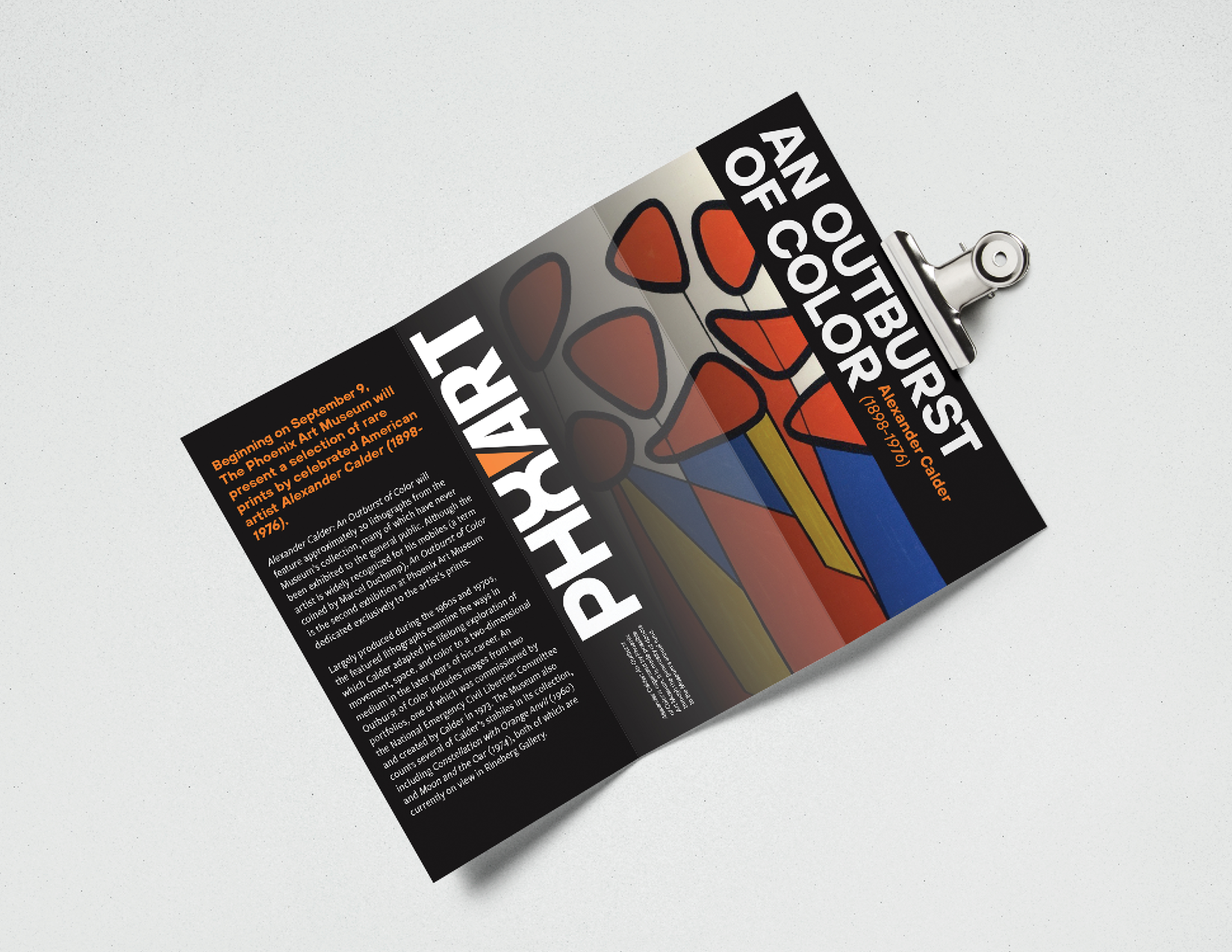 A brochure mockup, hung sideways on a wall. It shows my brand in use for an Alexander Calder exhibit. The brochure features bright, colorful and bold typography on a dark colored background. There is an image of Calder's work fading into the brochure between the front and center fold.
