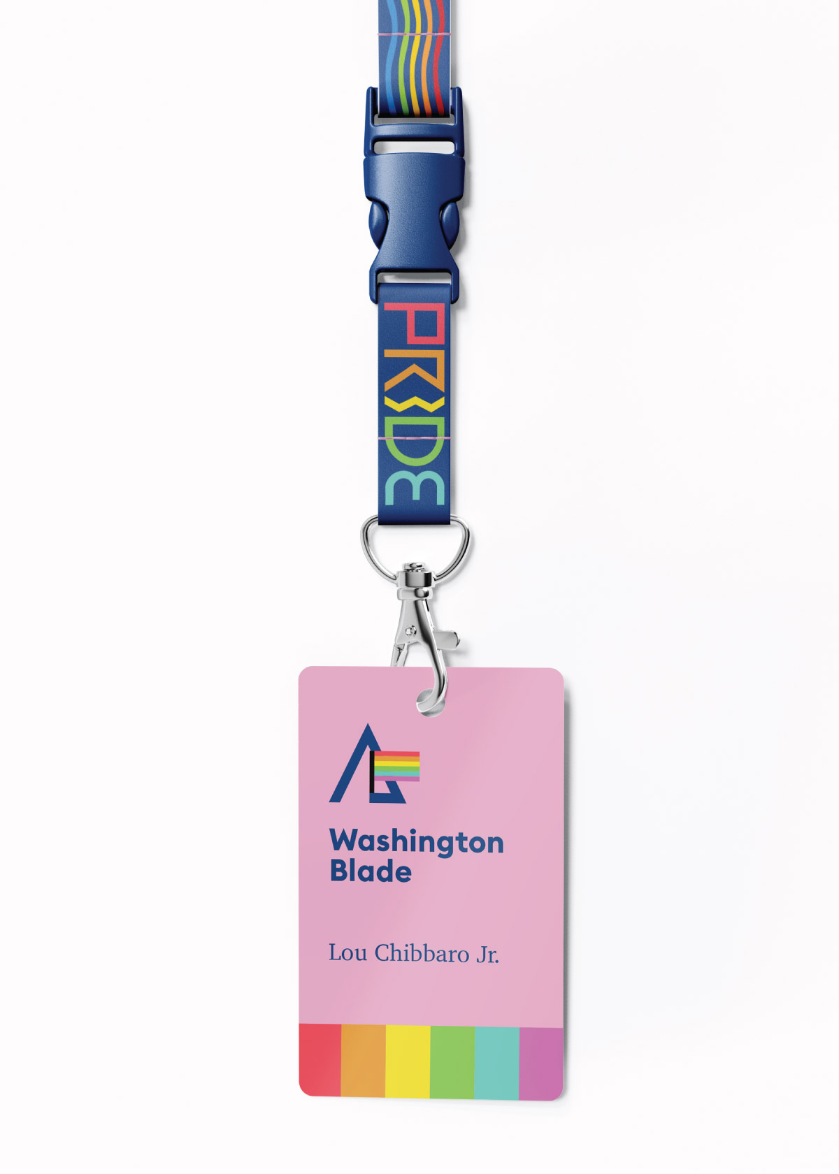 A mockup of what a pressbadge might look like. It features a navy blue lanyard with rainbow text and a wavy pattern, and a bright pink card is attached with the name of the news organization and reporter on it. A rainbow stripe sits on the bottom of the card.