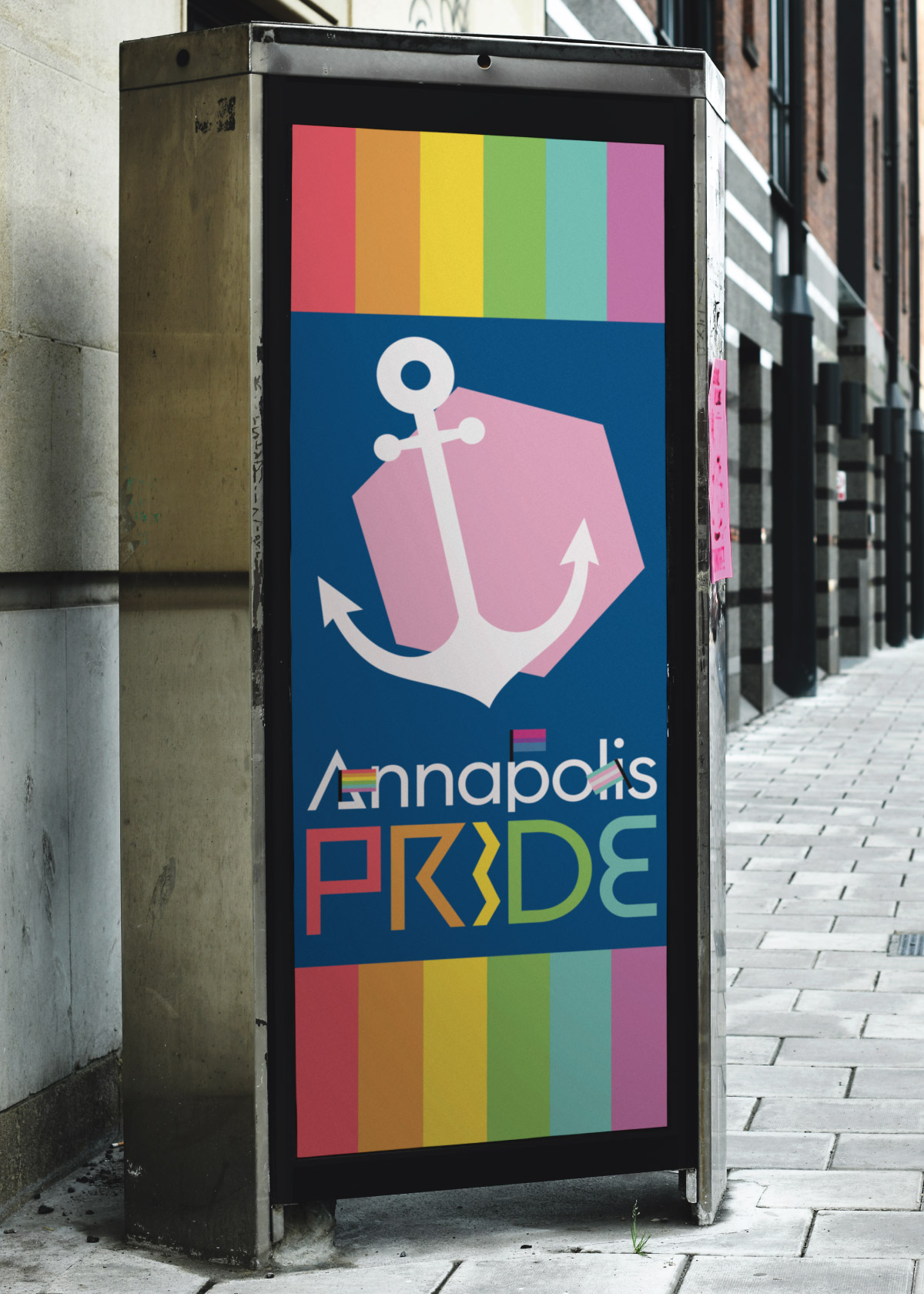 A mockup of what a bus advertisement might look like. It features the anchor icon from earlier on a hot pink backdrop, which is sitting on a navy blue background. Our Annapolis Pride logo is below, and there is a rainbow frame on the top and bottom of the sign.